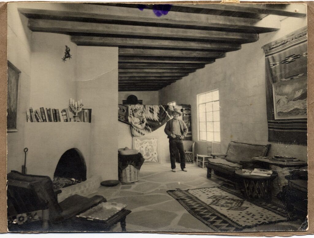 Alonzo “Lon” Megargee standing inside Casa Hermosa, his handcrafted adobe home and art studio in the 1930s.