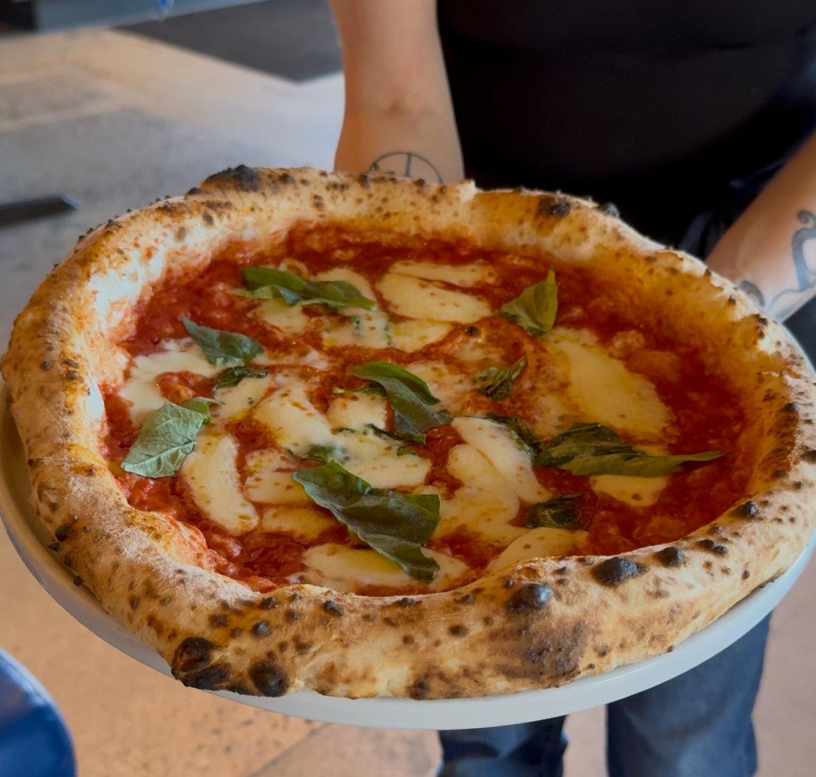 Margherita DOP pizza at Patricia’s Pizza with San Marzano tomato sauce, melted mozzarella and fresh basil on a charred crust.