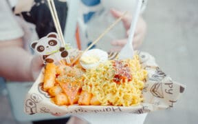 Asian street food dish with ramen, egg, fries and panda decal, served by a vendor at Panda Fest in Phoenix