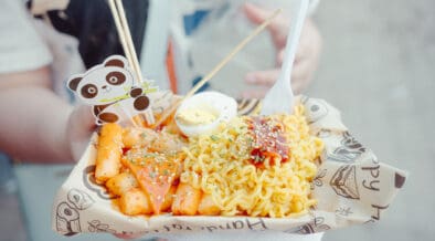 Asian street food dish with ramen, egg, fries and panda decal, served by a vendor at Panda Fest in Phoenix