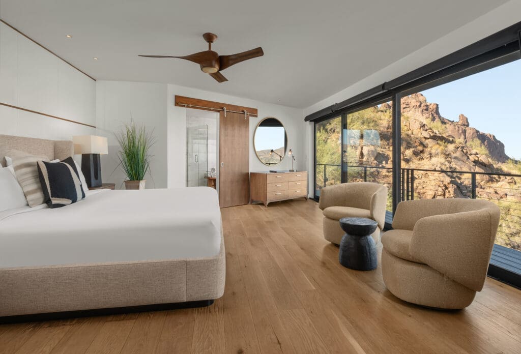 Light-filled guest room at Sanctuary Camelback Mountain with floor-to-ceiling windows and desert views.