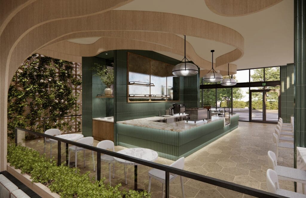 Interior view of The Nectarie Café at The Monarch San Antonio featuring a marble counter, green tile accents, café seating and soft natural light.