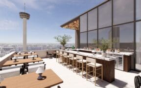 Rooftop bar and dining terrace at Aleteo at The Monarch San Antonio, featuring city views, modern seating and an open-air bar overlooking downtown.