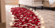 Rose petals and candlelight arranged on the floor of a luxury hotel suite at The Venetian Resort Las Vegas for a romantic Valentine’s Day setup.