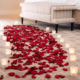 Rose petals and candlelight arranged on the floor of a luxury hotel suite at The Venetian Resort Las Vegas for a romantic Valentine’s Day setup.