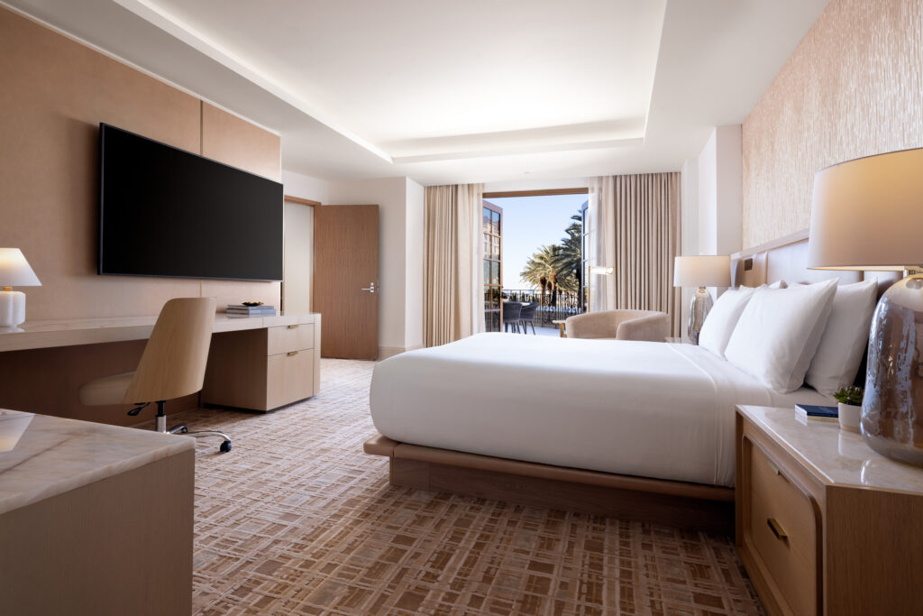 Strip Suite bedroom at Green Valley Ranch with king bed, modern desk workspace and neutral luxury decor.