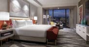 Luxury guest room at Conrad Las Vegas at Resorts World featuring floor-to-ceiling views of the Las Vegas Strip and modern interior design.