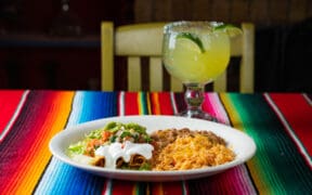 Mexican plate with rolled tacos, rice, beans, guacamole and margarita at Frank & Lupe’s in Scottsdale Arizona.