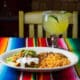 Mexican plate with rolled tacos, rice, beans, guacamole and margarita at Frank & Lupe’s in Scottsdale Arizona.