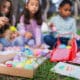 Family and friends are painting colorful easter eggs during an outdoor celebration in New Mexico.