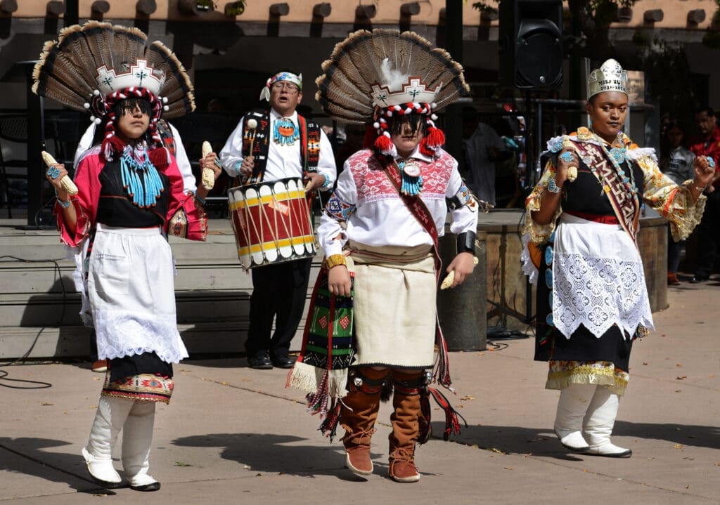 Pueblo dancers in traditional regalia performing during Easter celebrations in New Mexico.