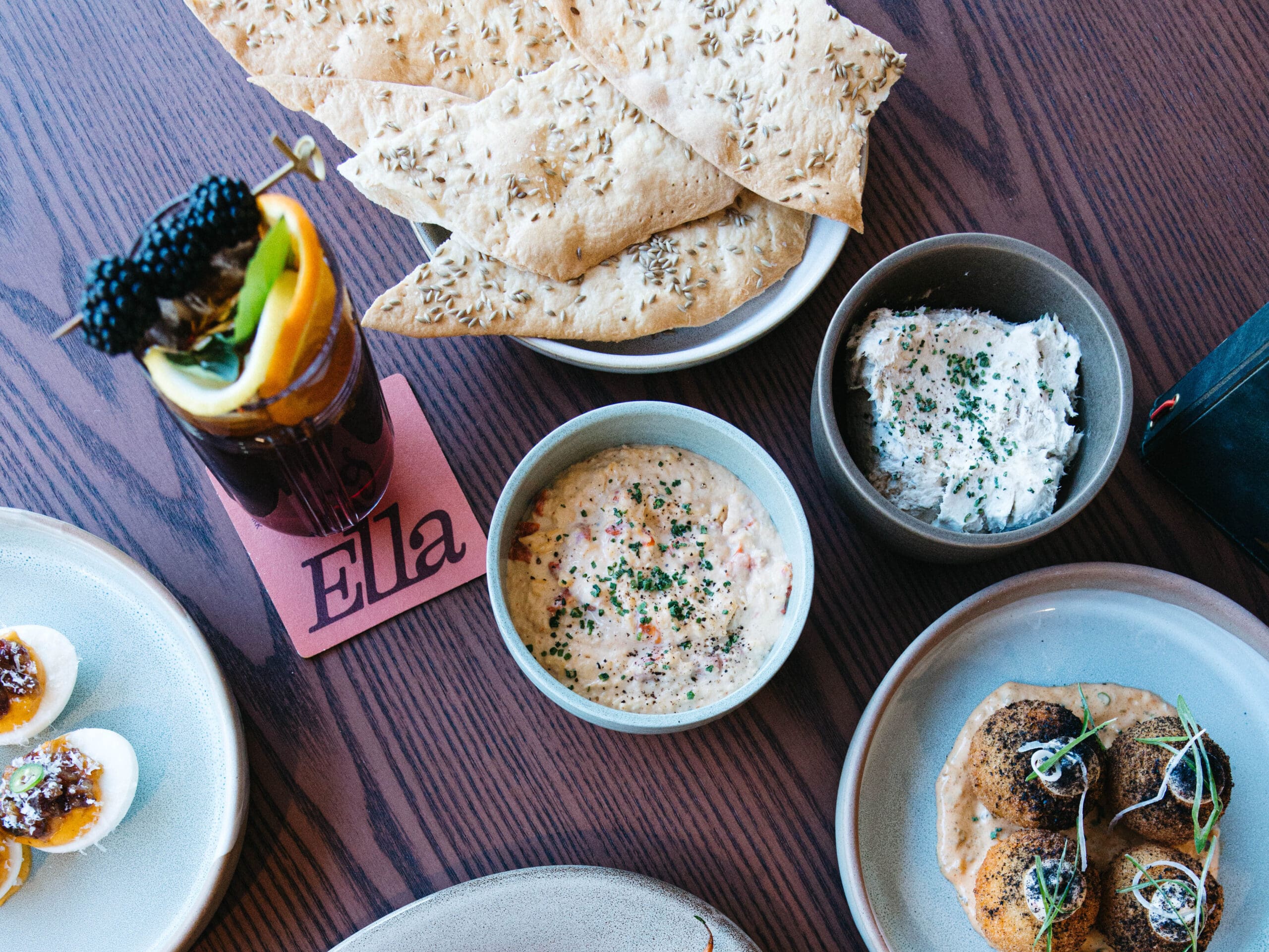 Plated dishes including steak, appetizers and cocktails at Hotel Solaya Scottsdale dining concept.