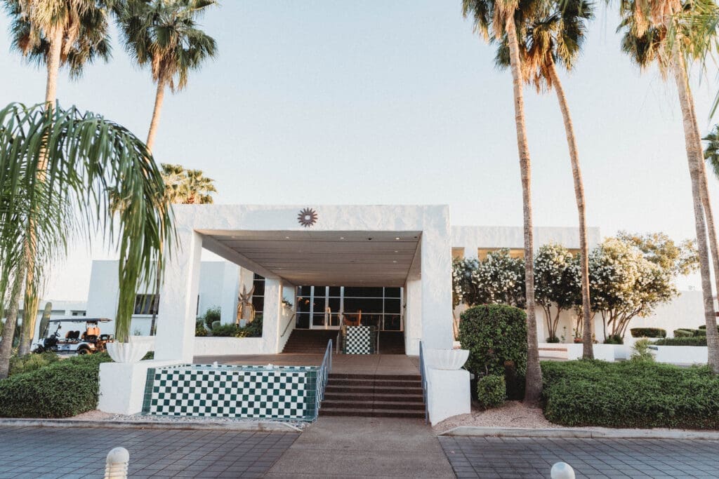 Exterior entrance of Hotel Solaya in Old Town Scottsdale with palm trees and desert landscaping.