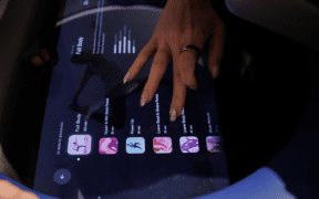 Close-up of a guest selecting massage settings on a digital screen for an AI-powered robotic massage at Spa by JW Austin.