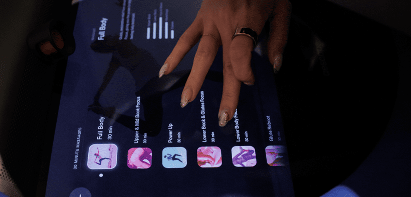Close-up of a guest selecting massage settings on a digital screen for an AI-powered robotic massage at Spa by JW Austin.