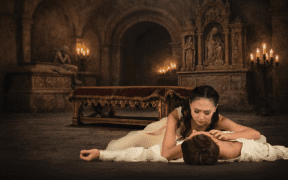 Ballet Arizona Romeo and Juliet performance with dancers in dramatic candlelit scene inside a cathedral-style set in Phoenix.