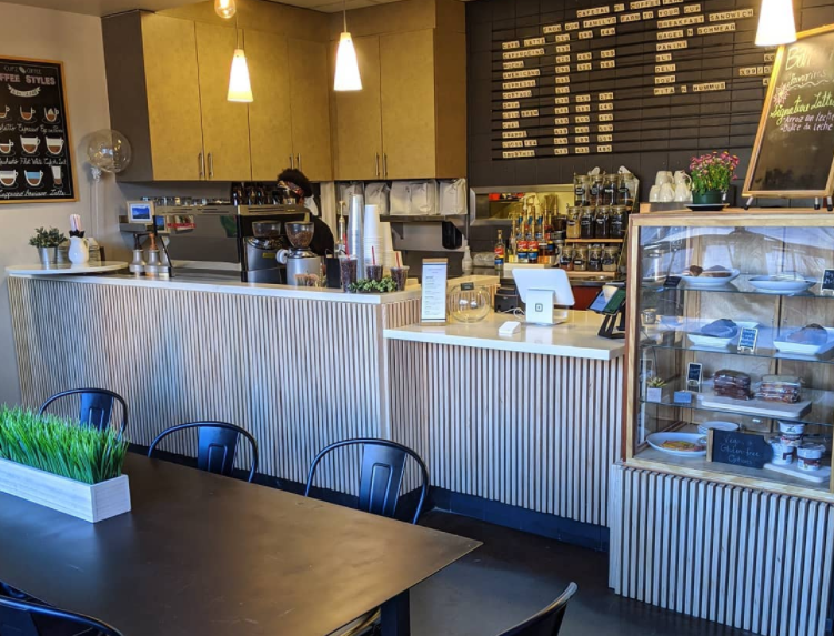 Coffee shop interior with espresso machine, menu board and counter setup at Cafetal Coffee.