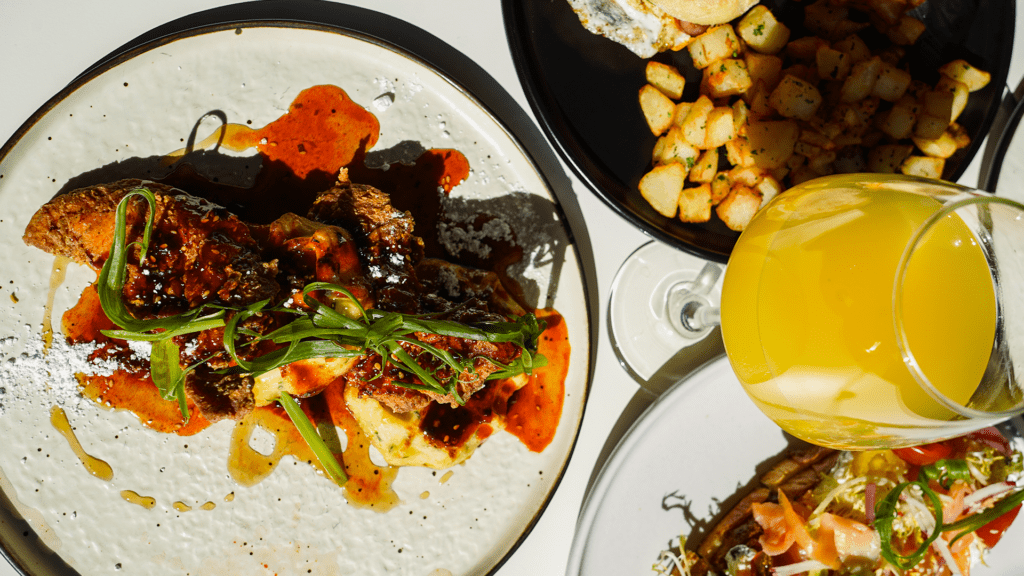 Brunch spread at Harland Brewing Company in San Diego featuring savory dishes, potatoes and brunch cocktails in a casual setting.