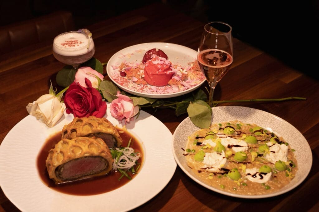 Mother’s Day dining spread at Huntress in San Diego featuring steakhouse dishes, desserts and cocktails in an upscale restaurant setting.