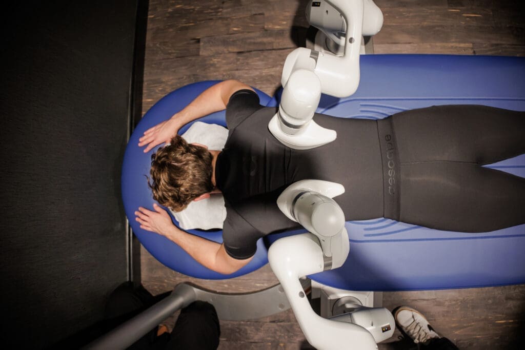 Overhead view of a person receiving a robotic massage from AI-powered arms on a spa table at JW Marriott Austin.