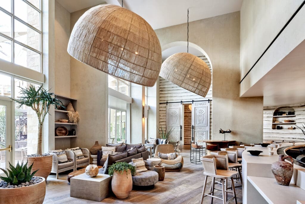 Modern lobby lounge at JW Marriott Phoenix Desert Ridge Resort & Spa featuring large woven pendant lights, neutral tones, wood accents and a spacious, design-forward interior in Phoenix.