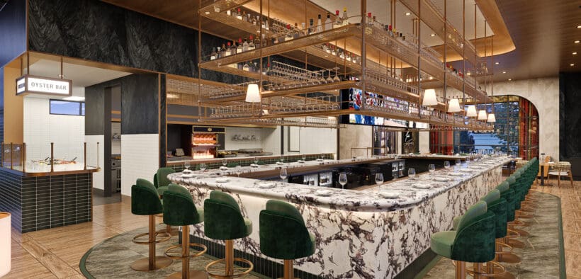 Elevated marble bar with swivel bar chairs and gold, liquor interior design element at Jack's Modern Steakhouse Lone Tree.