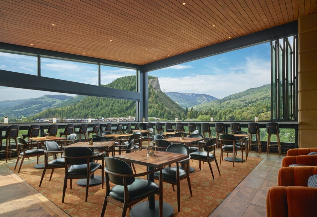 Spacious bar with mountain views at Lookout Bar in Avon Colorado, featuring seating and large windows overlooking Beaver Creek landscape.