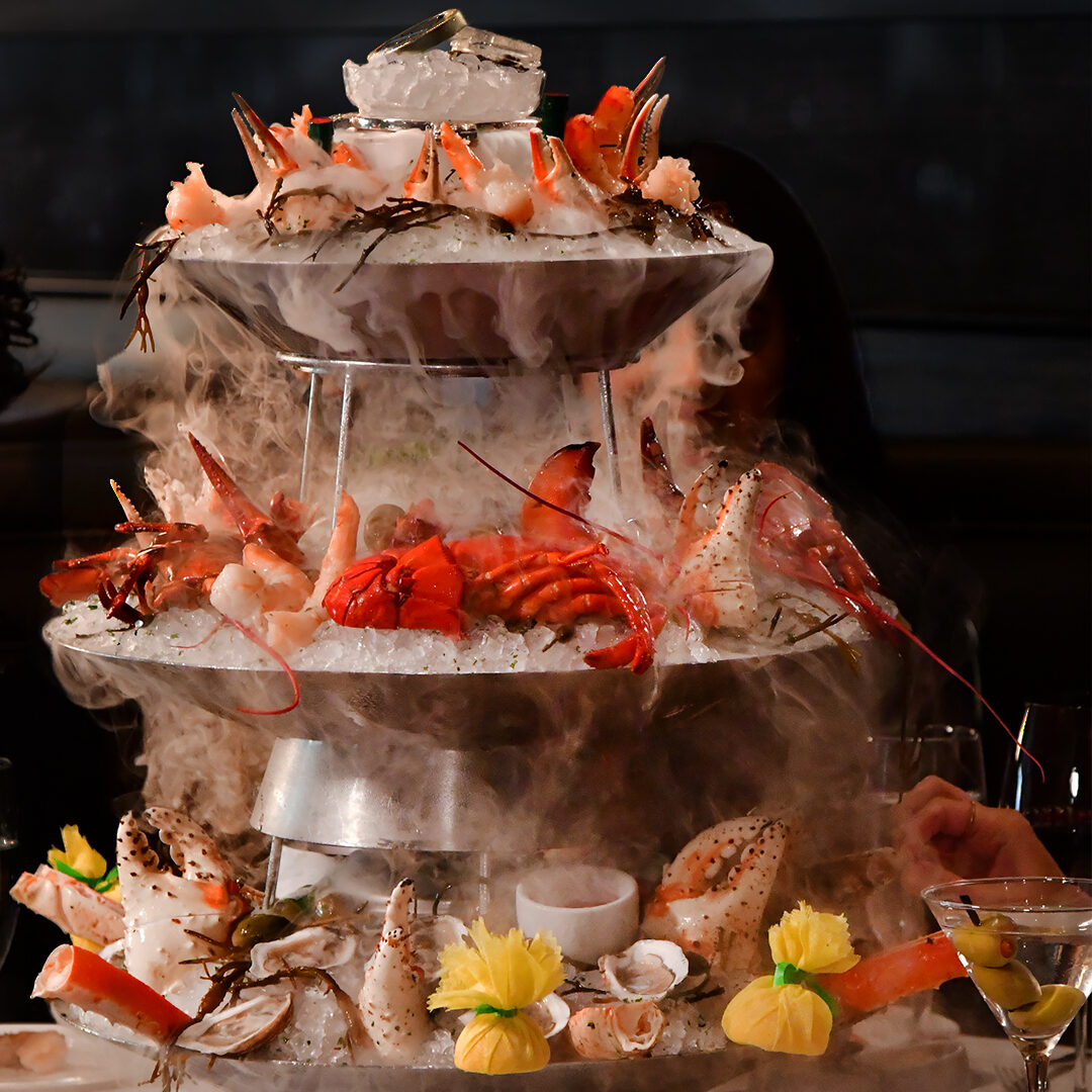 Multi-tier seafood tower with lobster, shrimp and shellfish on ice at Mastro’s Steakhouse.