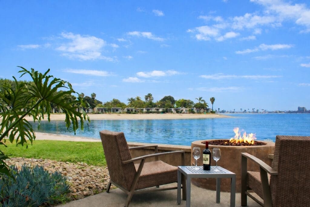 Two chairs near a fire pit overlooking  Mission Bay at the Paradise Point resort.