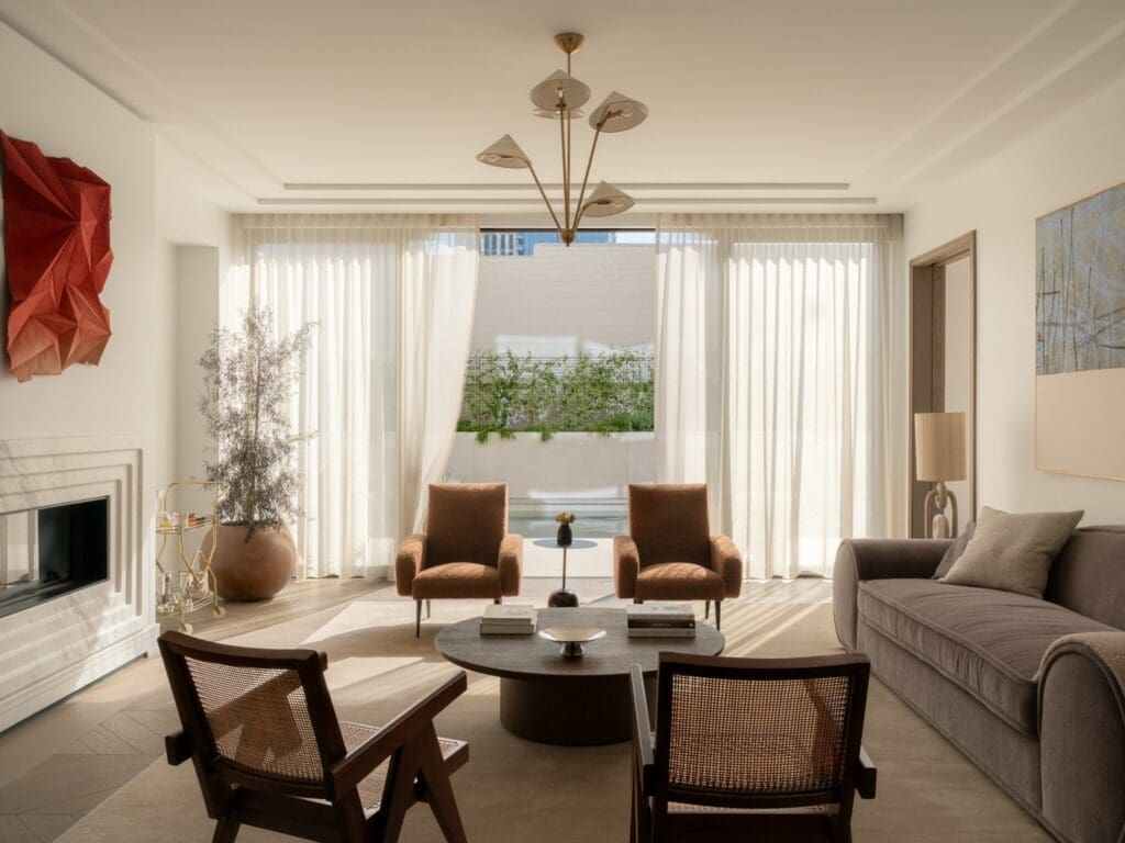 Bright modern living room with large windows and terrace at Rosewood Residences Beverly Hills luxury homes.