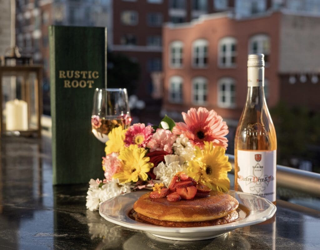 Strawberry pancakes at Rustic Root in San Diego topped with fresh fruit and syrup, served as part of a Mother’s Day brunch menu.