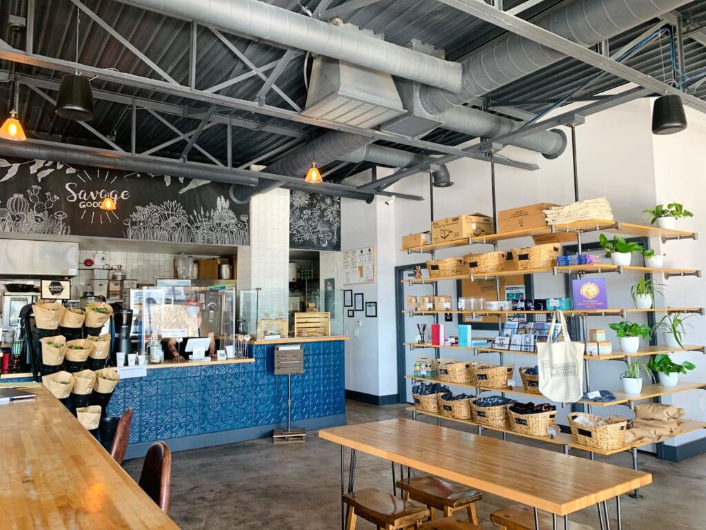 The interior of Savage Goods cafe in El Paso with counter seating, shelves and modern decor.