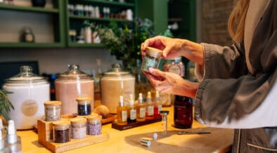 Guest creating custom body scrub with botanical ingredients at L’Apothecary Spa at L’Auberge de Sedona in Sedona Arizona.