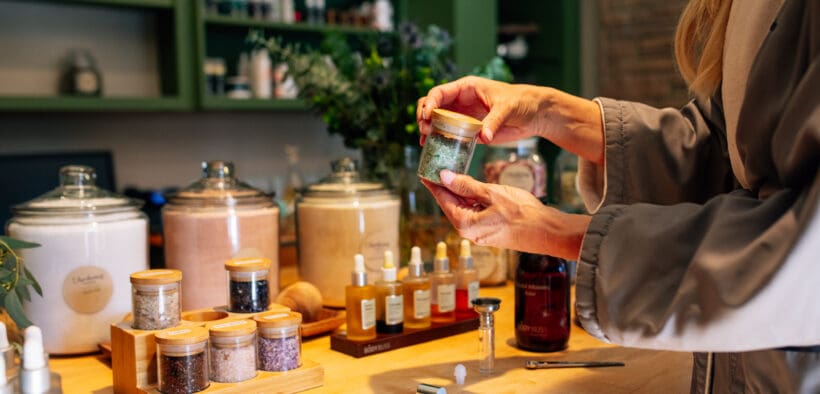 Guest creating custom body scrub with botanical ingredients at L’Apothecary Spa at L’Auberge de Sedona in Sedona Arizona.