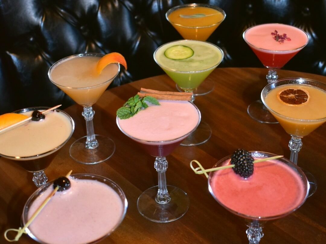 Assorted colorful brunch cocktails served in coupe glasses at The Windsor.
