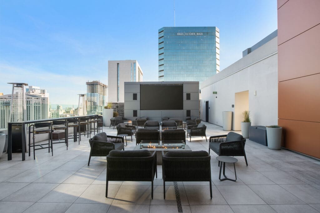 Modern rooftop lounge with firepit seating and city skyline views at Carté Hotel San Diego Downtown in Little Italy.