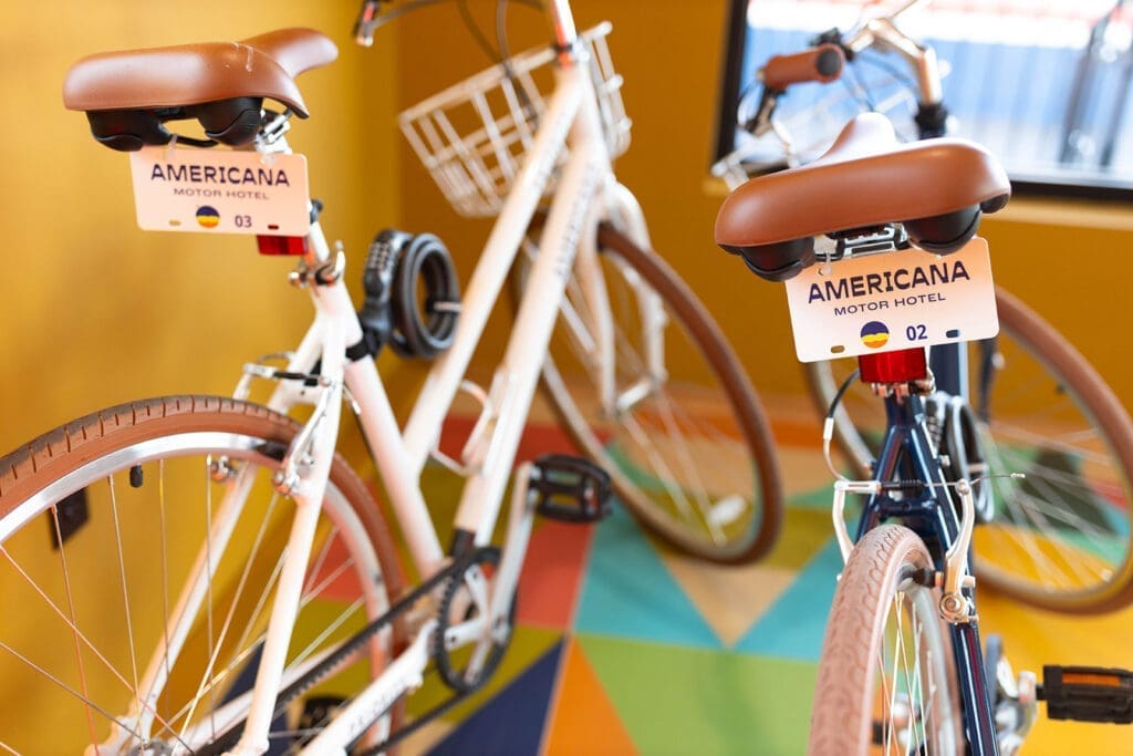 Complimentary cruiser bikes inside Americana Motor Hotel in Flagstaff, Arizona, featuring retro-inspired design and colorful Route 66-style décor.