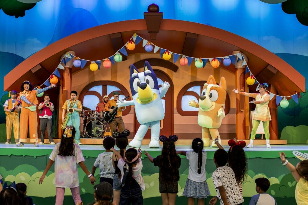 Bluey and Bingo perform on stage during "Bluey's Best Day Ever!" at Disneyland Resort's Fantasyland Theatre.