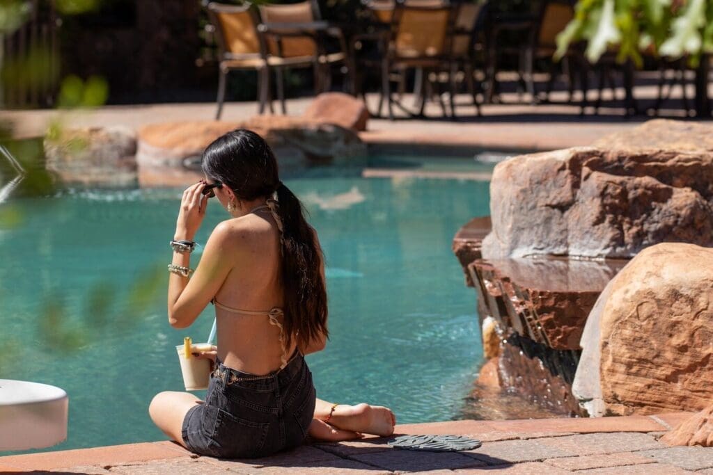 Guest relaxing beside the pool at Gateway Canyons Resort & Spa in Western Colorado.