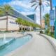 Exterior view of Hilton Anaheim with palm trees, fountain and resort entrance near Disneyland Resort in Anaheim, California.