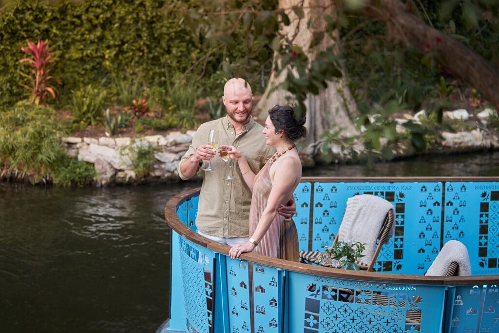 Couple enjoying a Champagne toast on a private River Walk boat experience in San Antonio.