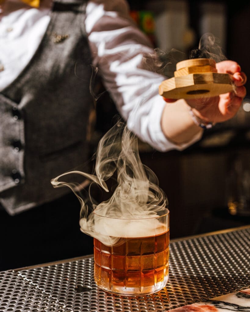 Smoked cocktail being prepared at Kimpton Santo rooftop bar in San Antonio.