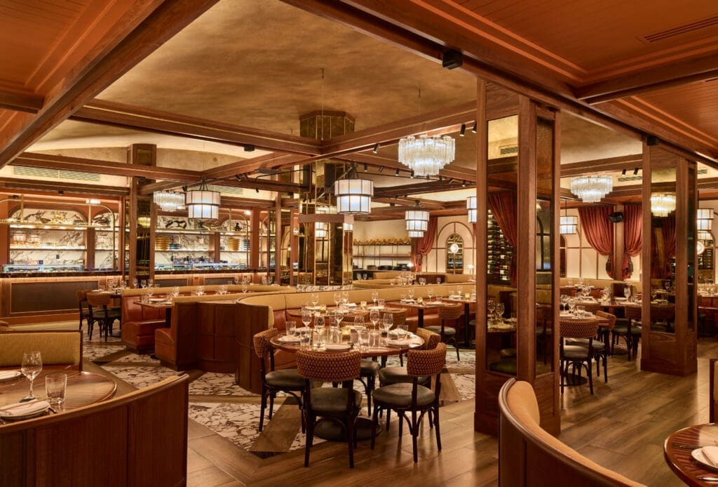 The CATCH upscale main dining room with luxury set tables, hardwood floors and elevated lighting.