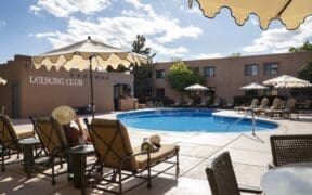 Pool area and lounge chairs at Hotel Glorieta in Santa Fe, New Mexico on a sunny afternoon.