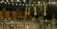 Outdoor patio dining at Quiessence in Phoenix with string lights and candlelit tables at night.