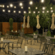 Outdoor patio dining at Quiessence in Phoenix with string lights and candlelit tables at night.