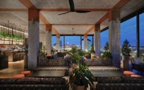 Tenfold Rooftop lounge overlooking downtown San Antonio at night.