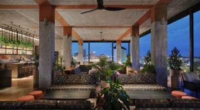 Tenfold Rooftop lounge overlooking downtown San Antonio at night.