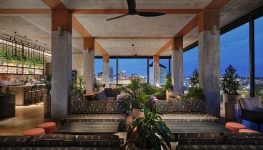 Tenfold Rooftop lounge overlooking downtown San Antonio at night.