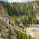 Guests cross a suspension bridge on the Via Ferrata course at Taos Ski Valley during a guided summer mountain adventure.